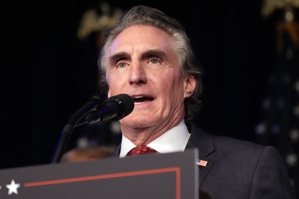 North Dakota Gov. Doug Burgum speaks as Republican presidential candidate former President Donald Trump attends a caucus night rally in Las Vegas, Thursday, Feb. 8, 2024. (AP Photo/Alex Brandon)