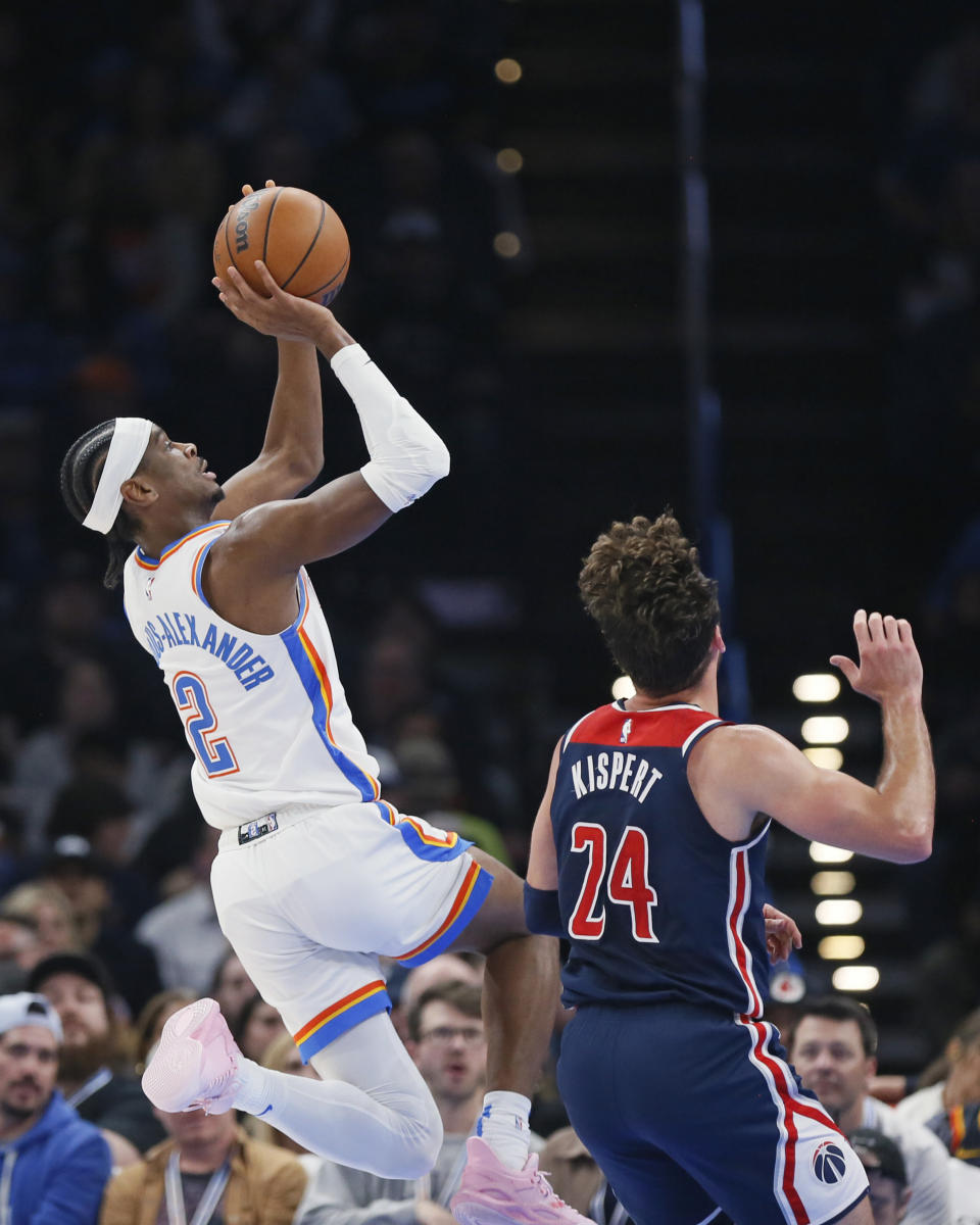 Oklahoma City Thunder guard Shai Gilgeous-Alexander prepares to shoot next to Washington Wizards forward Corey Kispert (24) during the first half of an NBA basketball game Friday, Feb. 23, 2024, in Oklahoma City. (AP Photo/Nate Billings)