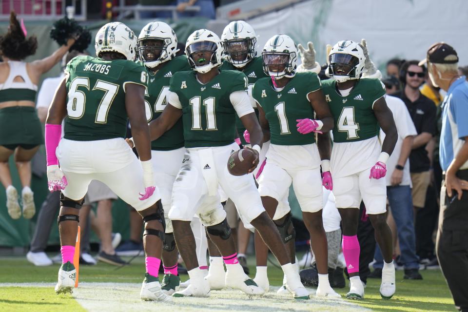 South Florida quarterback Gerry Bohanon (11) celebrates with teammates after scoring a touchdown against Tulane Saturday, Oct. 15, 2022, in Tampa, Fla. Bohanon, who landed at BYU via the transfer portal, will be among the QBs competing for the starting job in Provo when the Cougars open spring drills. | Chris O’Meara, Associated Press