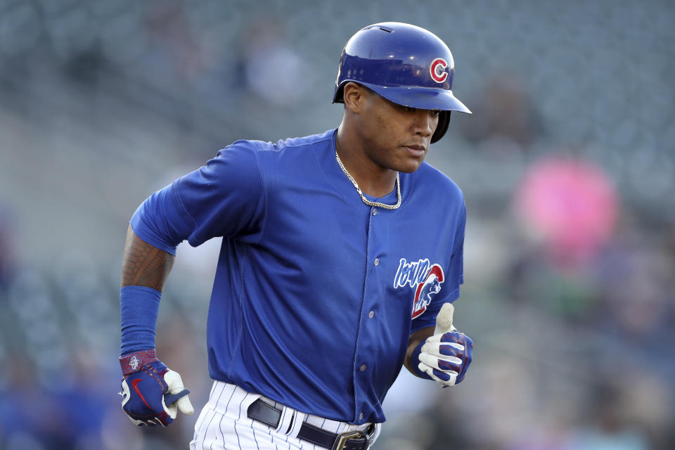 Iowa Cubs shortstop Addison Russell runs to first base during a Triple-A baseball game against the Nashville Sounds, Wednesday, April 24, 2019, in Des Moines, Iowa. Russell played in his first game of the season Wednesday for Iowa as he prepares to return to the Chicago Cubs following his domestic violence suspension. (AP Photo/Charlie Neibergall)