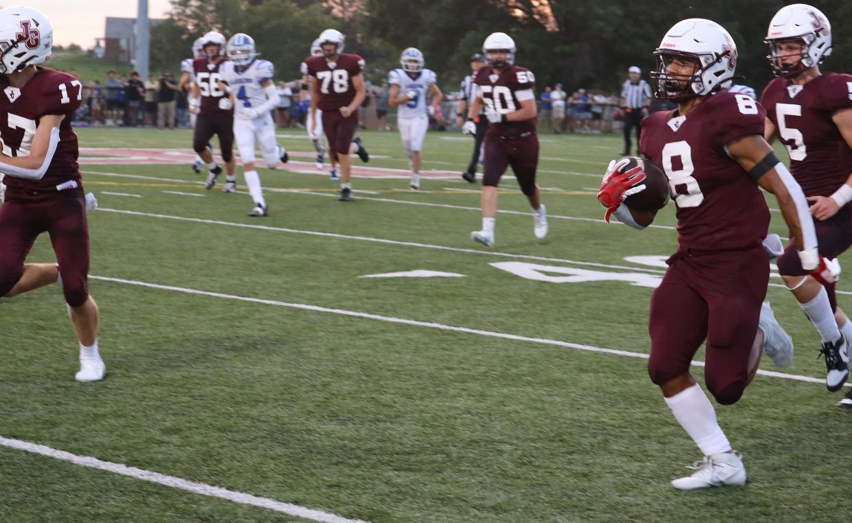 John Glenn's Reese Metzger (8) carries the ball to the end-zone during the Muskies versus Bobcat football game at John Glenn High School Friday night.