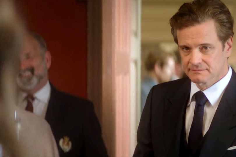 Still from Bridget Jones's Baby trailer of Colin Firth wearing a suit and tie with a neutral facial expression