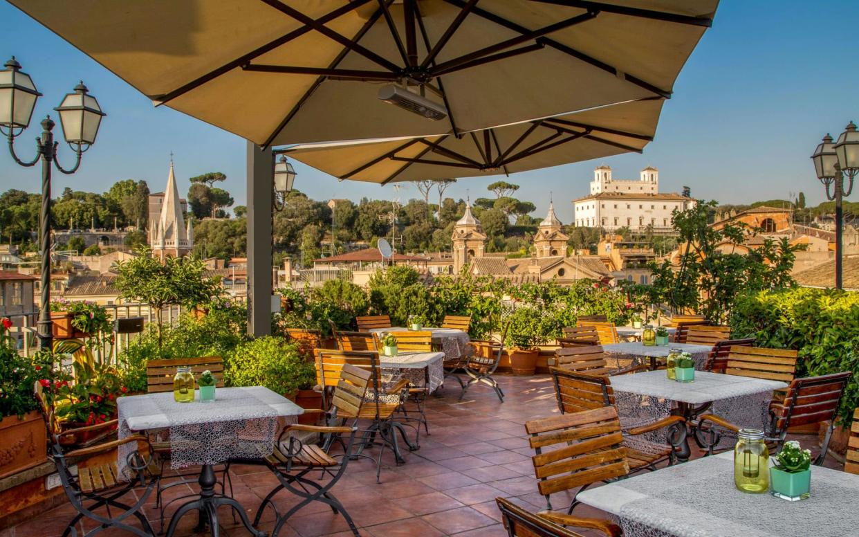 Breakfast is served on the roof at Hotel Mozart in summer, and a range of room configurations will suit families of all ages