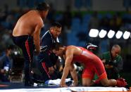 <p>Mongolias coaches protest the judges decision after Mandakhnaran Ganzorig (red) of Mongolia is defeated by Ikhtiyor Navruzov (blue) of Uzbekistan in the Men’s Freestyle 65kg Bronze match against on Day 16 of the Rio 2016 Olympic Games at Carioca Arena 2 on August 21, 2016 in Rio de Janeiro, Brazil. (Getty) </p>