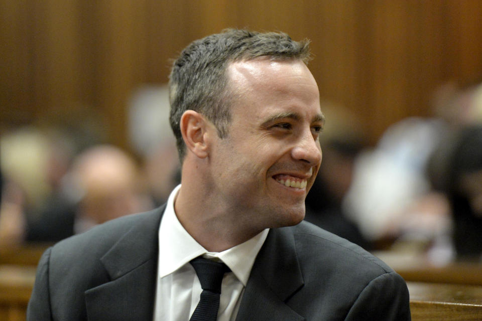 Oscar Pistorius smiles in court during his trial at the high court in Pretoria, South Africa, Monday, March 3, 2014. Pistorius is charged with murder with premeditation in the shooting death of girlfriend Reeva Steenkamp in the pre-dawn hours of Valentine's Day 2013. (AP Photo/Herman Verwey Media24-Pool)