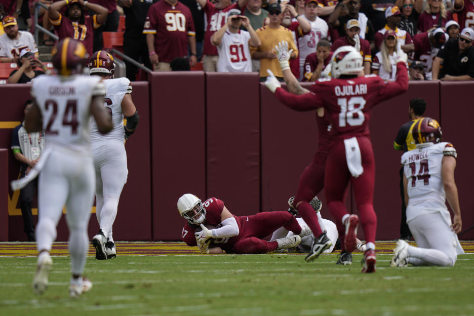 Arizona Cardinals linebacker Cameron Thomas (97) scores a touchdown after recovering a fumble by Washington Commanders quarterback Sam Howell (14) during the first half of an NFL preseason football game, Sunday, Sept. 10, 2023, in Landover, Md. Also seen are Washington Commanders safety Antonio Gibson (24) and Arizona Cardinals linebacker BJ Ojulari (18). (AP Photo/Alex Brandon)