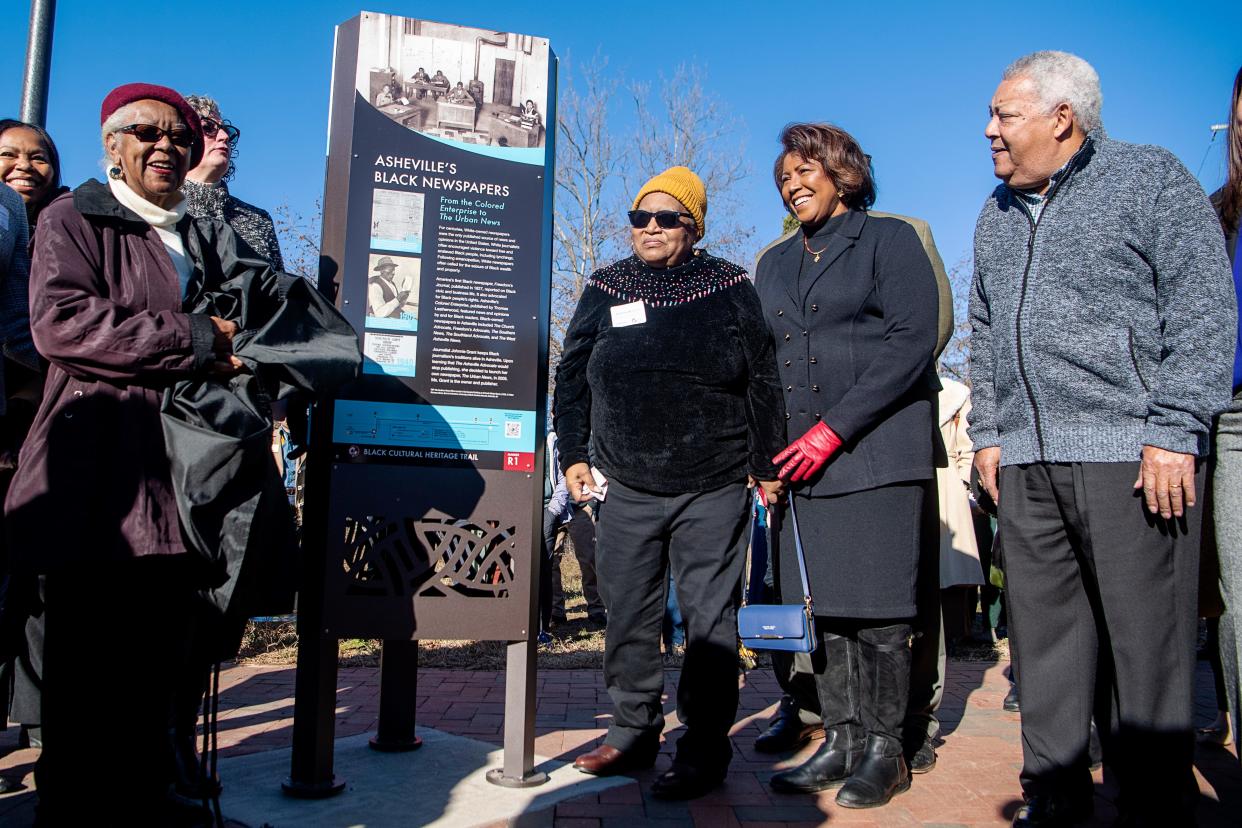 From left, Catherine Mitchell, Alberta Williams, Vice Mayor Sandra Kilgore, and Buncombe County Commissioner Al Whitesides, stand next to an unveiled historical marker along the Asheville Black Cultural Heritage Trail in the River Arts District, December 15, 2023.