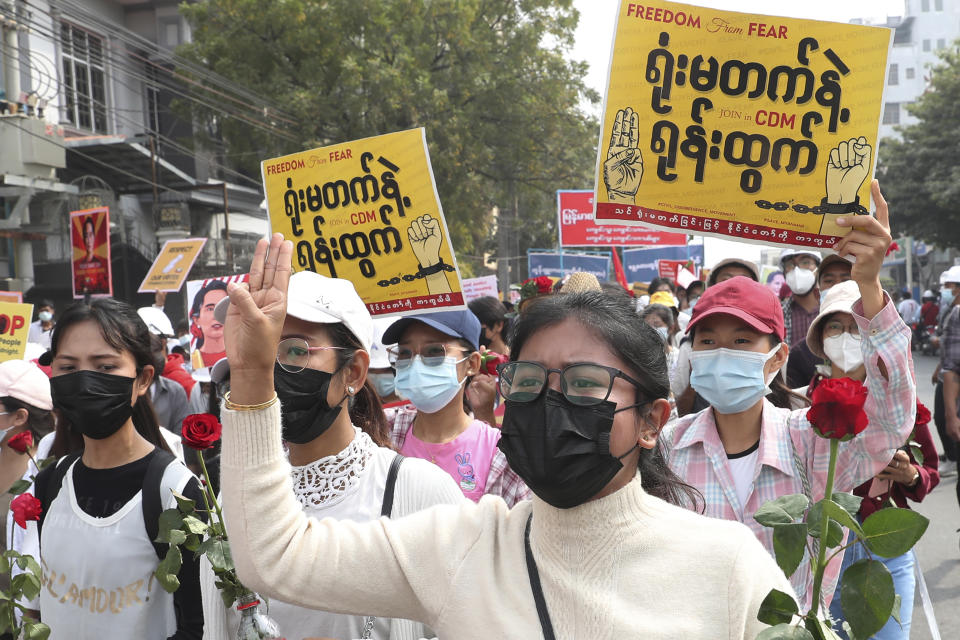 A woman flashes the three-fingered salute during an anti-coup protest rally in Mandalay, Myanmar Saturday, Feb. 20, 2021. Anti-coup protesters in Myanmar's two largest cities on Saturday paid tribute to the young woman who died a day earlier after being shot by police during a rally against the military takeover. (AP Photo)