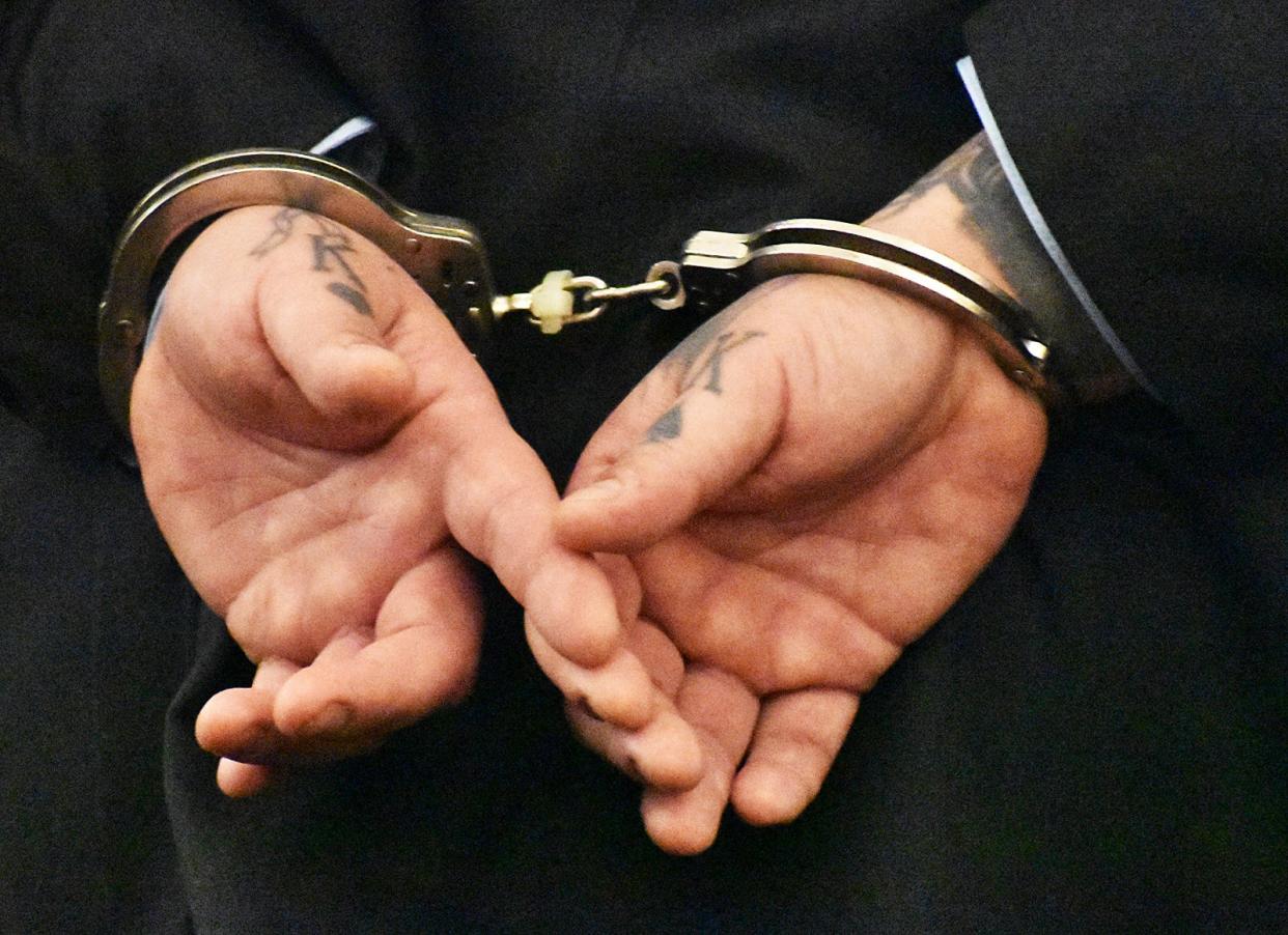 Nelson Coelho's tattooed hands are cuffed behind his back as he listens to his sentencing for the murder of Lal Kishor Mahaseth in Bristol County Superior Court on Tuesday, May 7, 2024.