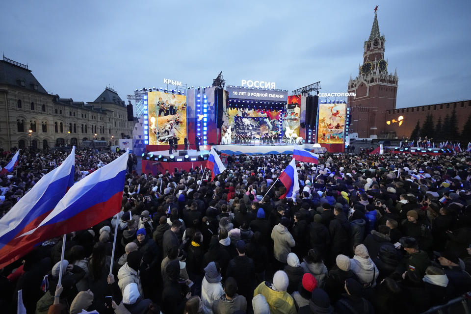 People watch a concert marking the 10-year anniversary of Crimea's annexation by Russia on Red Square in Moscow, Russia, Monday, March 18, 2024. President Vladimir Putin seized Crimea from Ukraine a decade ago, a move that sent his popularity soaring but was widely denounced as illegal. (AP Photo/Alexander Zemlianichenko)