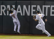 Oakland Athletics center fielder Starling Marte (2) cannot catch a double hit by Seattle Mariners' Mitch Haniger next to right fielder Chad Pinder (4) during the fifth inning of a baseball game in Oakland, Calif., Monday, Sept. 20, 2021. (AP Photo/Jeff Chiu)