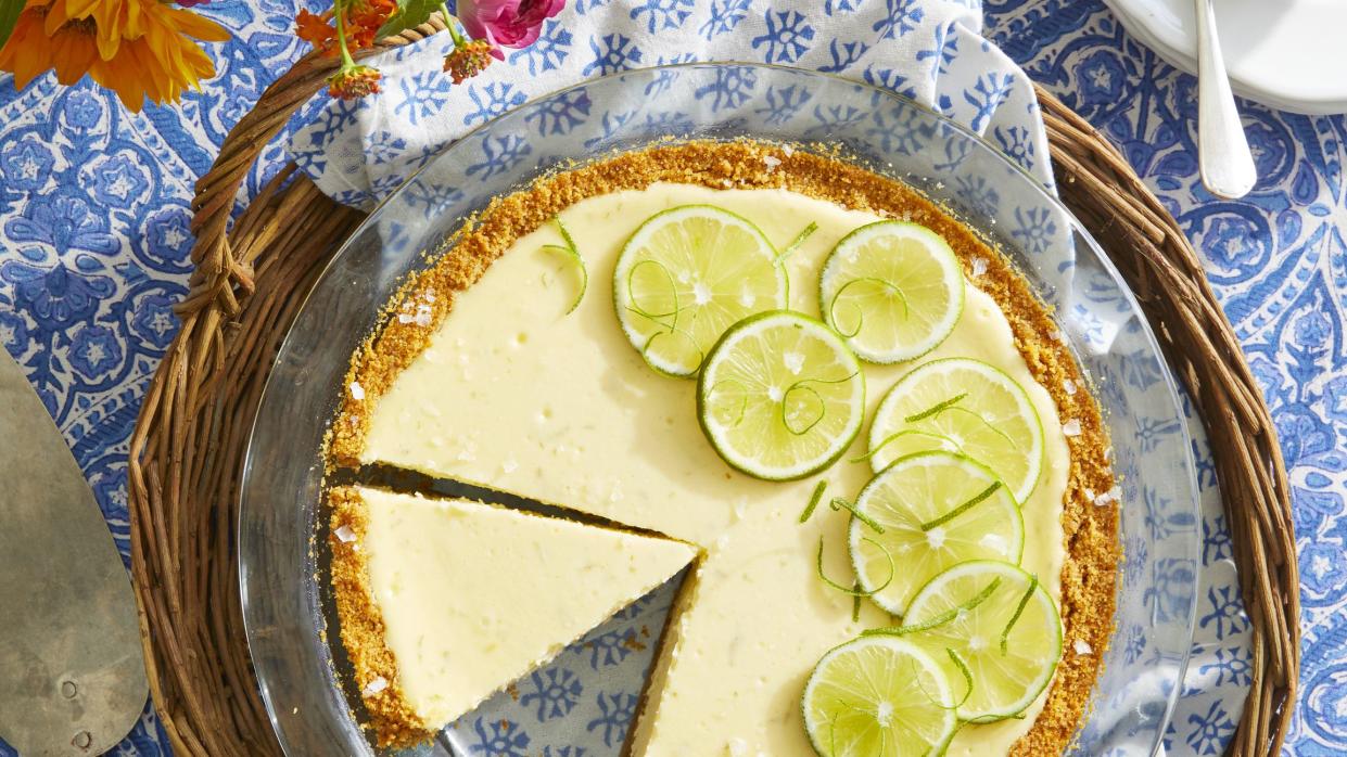 a pie dish with a margarita cheesecake with spiked whipped cream