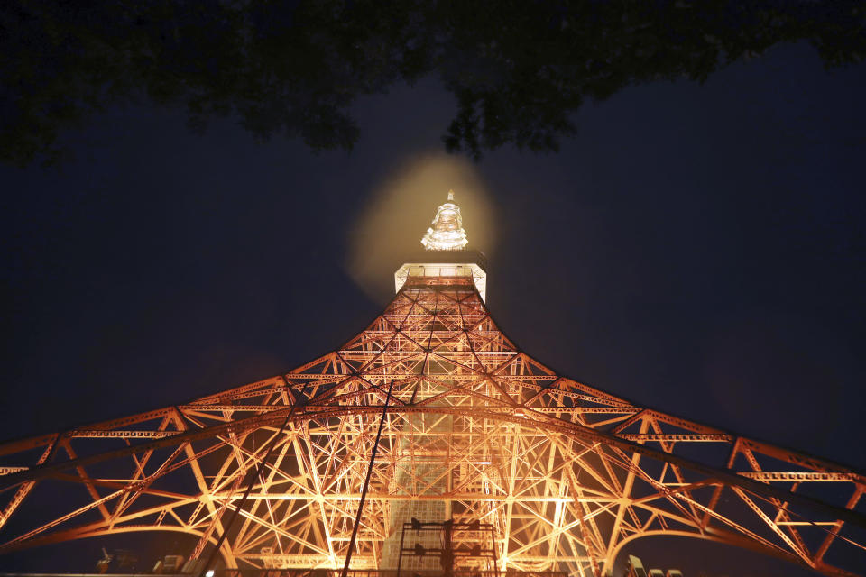 Tokyo Tower is lit in the pouring rain due to Typhoon Hagibis in Tokyo Saturday, Oct. 12, 2019. A heavy downpour and strong winds pounded Tokyo and surrounding areas on Saturday as a powerful typhoon forecast as the worst in six decades approached landfall, with streets and train stations deserted and shops shuttered. (AP Photo/Eugene Hoshiko)
