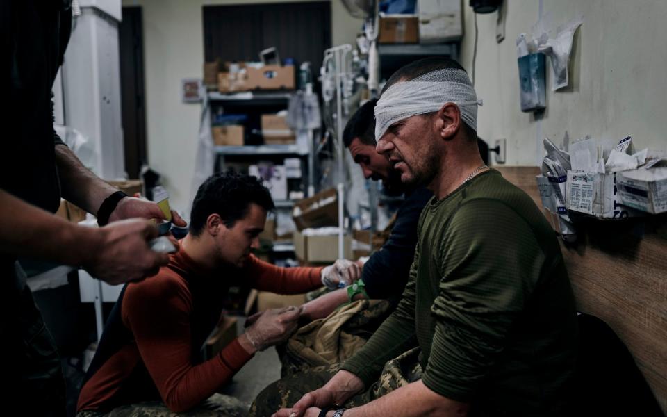 Ukrainian soldiers receive first aid in a hospital in Bakhmut - Libkos/AP