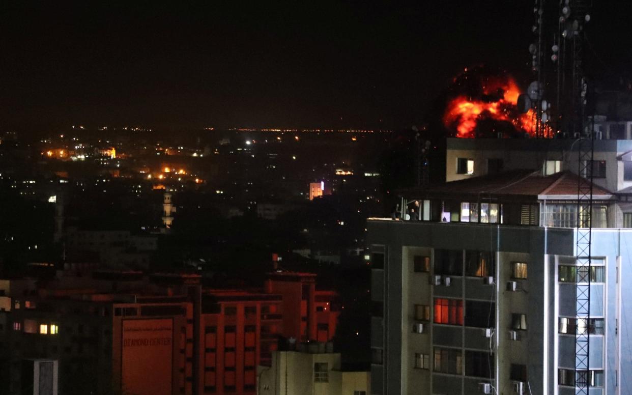 Fire and smoke are seen during an Israeli air strike in Gaza City - REUTERS