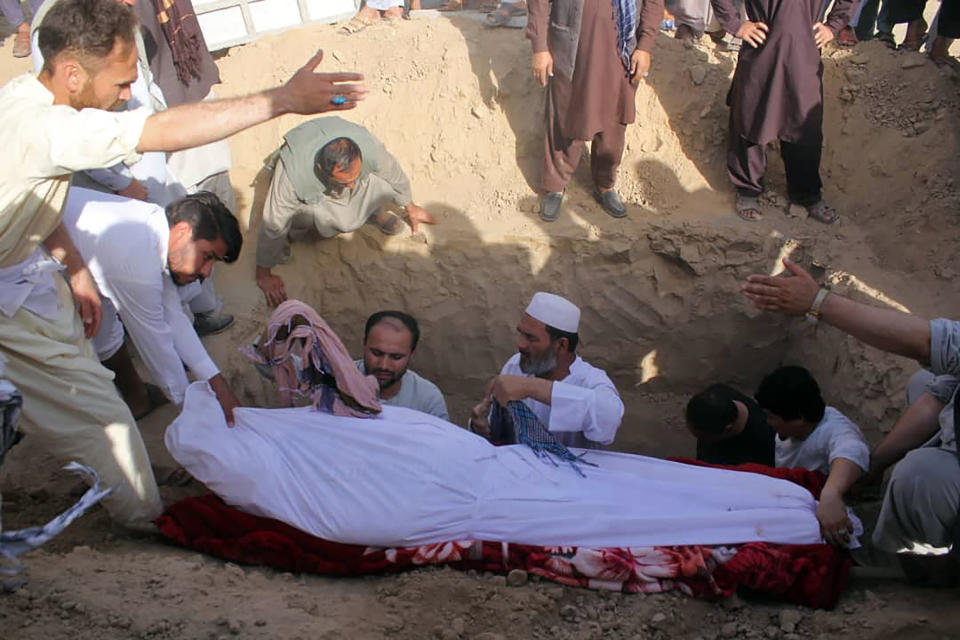 Men bury Sayed Sarwar Hussaini, the spokesperson of the Kunduz Police headquarters, who was killed in a suicide attack on Saturday, in Kunduz province, north of Kabul, Afghanistan, Sunday, Sept. 1, 2019. The Taliban attacked a second Afghan city in as many days on Sunday and killed several members of security forces, officials said, even as Washington's peace envoy said the U.S. and the militant group are "at the threshold of an agreement" to end America's longest war. (AP Photo/Bashir Khan Safi)