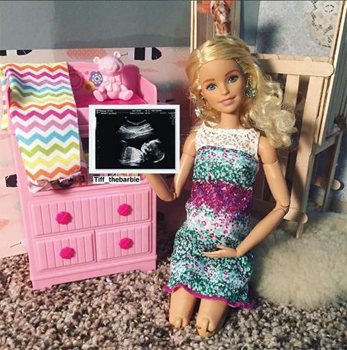 Barbie cradles her petite baby bump in her 8-month update post.