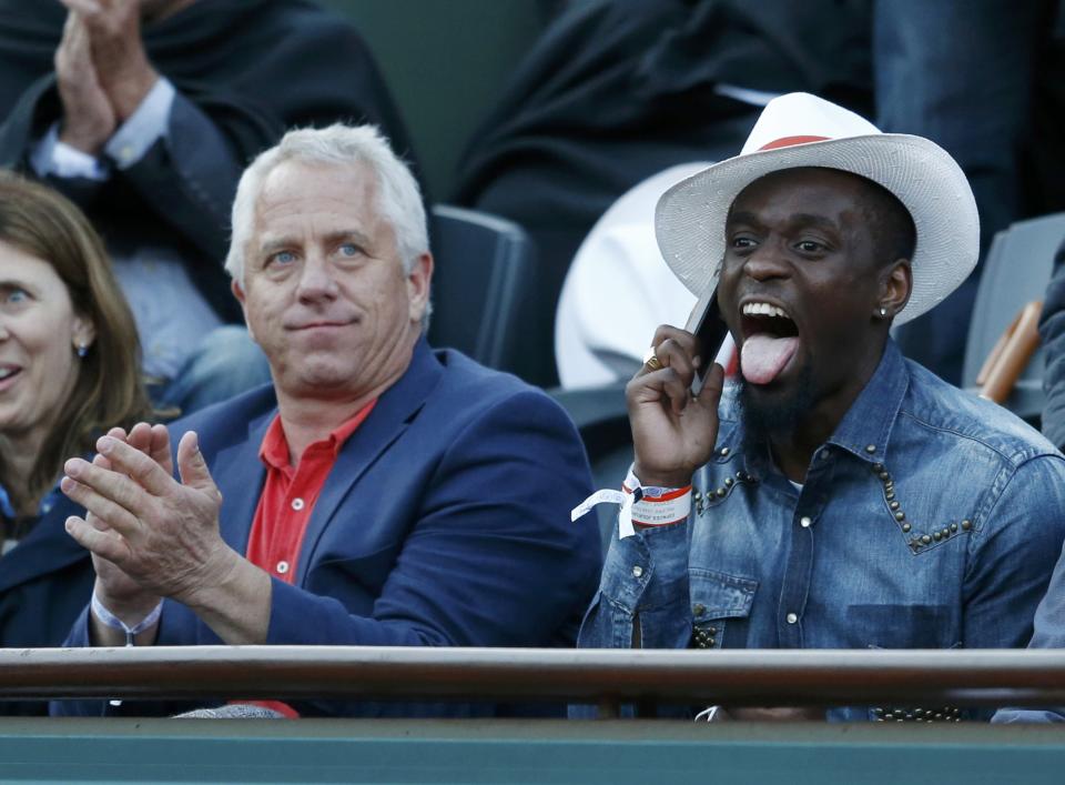 Former US cycling rider Greg LeMond and French triple jumper and long jumper Teddy Tamgho attend the men's quarter-final match between Murray and Monfils during the French Open Tennis tournament in Paris