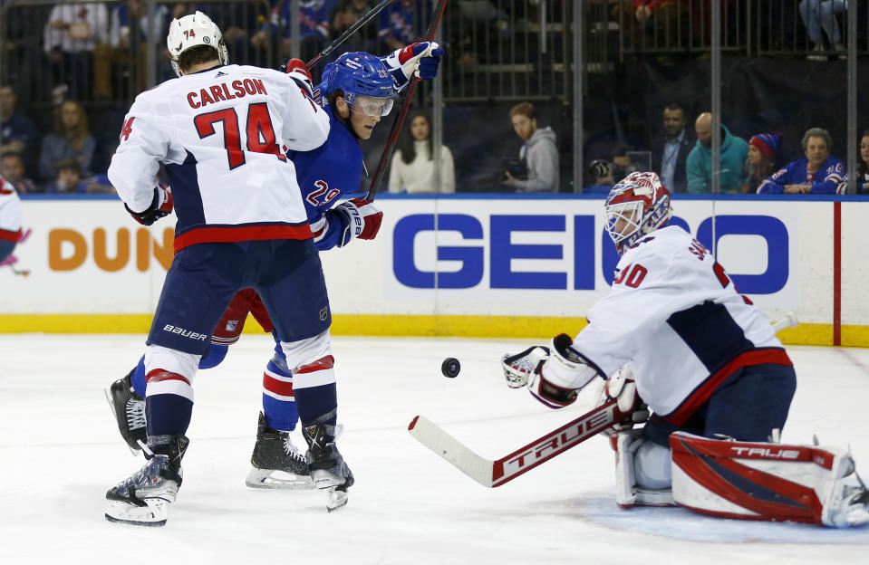 Washington Capitals' goalie Ilya Samsonov stops the puck while teammate John Carlson (74) defends against New York Rangers' Dryden Hunt (29) during the second period of an NHL hockey game Thursday, Feb. 24, 2022, in New York. (AP Photo/John Munson)