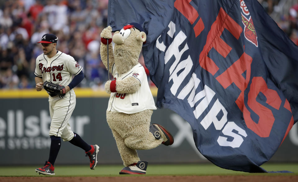 Atlanta Brave mascot 'Blooper' follows Braves' Adam Duvall (14) off the field at the end of a baseball game against the New York Mets Sunday, Oct. 3, 2021, in Atlanta. (AP Photo/Ben Margot)
