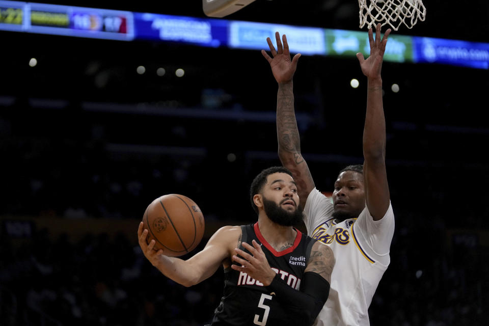 Houston Rockets guard Fred VanVleet, left, drives against Los Angeles Lakers forward Cam Reddish, right, during the first half of an NBA basketball game in Los Angeles, Sunday, Nov. 19, 2023. (AP Photo/Eric Thayer)