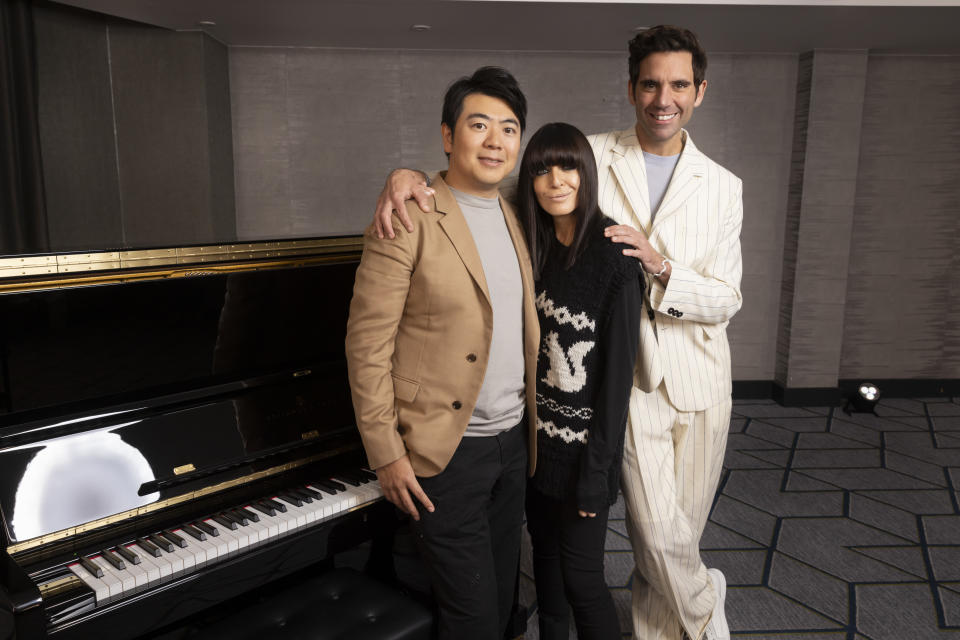 Claudia Winkleman, Mika and Lang Lang pose in front of a piano