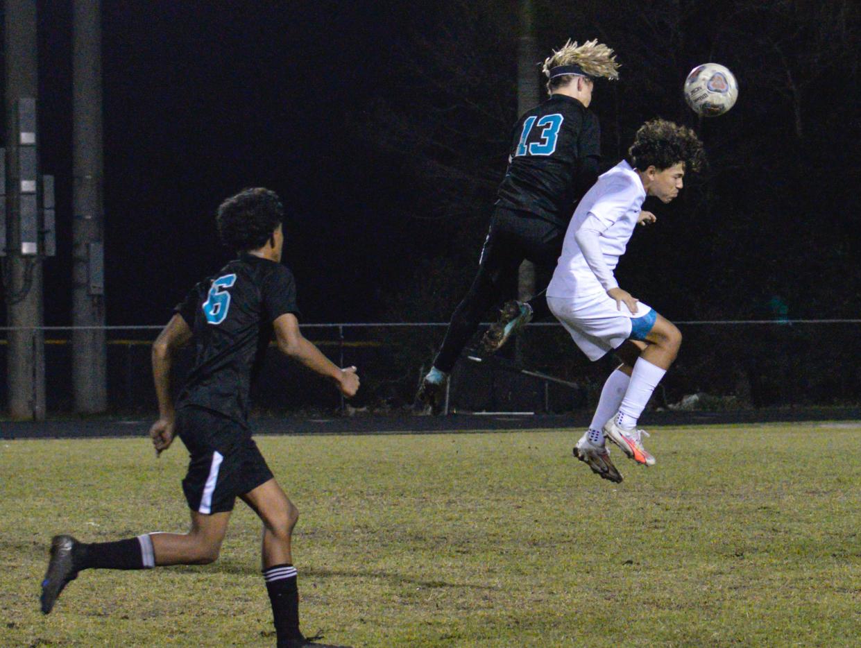 Royal Palm Beach's Nash Mumma (13) leaps to head the ball in Tuesday's district championship against John I. Leonard on Jan. 30, 2024.