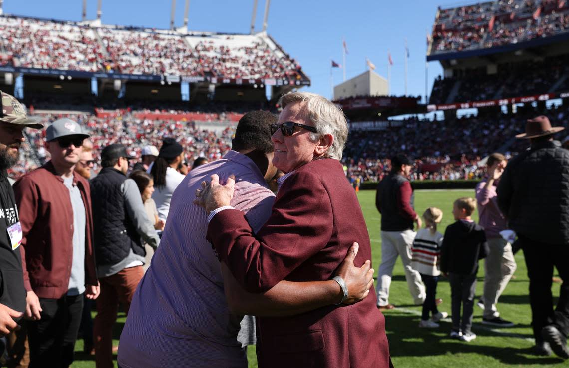 Former South Carolina coach Steve Spurrier is greeted by former players during halftime of the Gamecocks’ game at Williams-Brice Stadium in Columbia on Saturday, November 4, 2023.