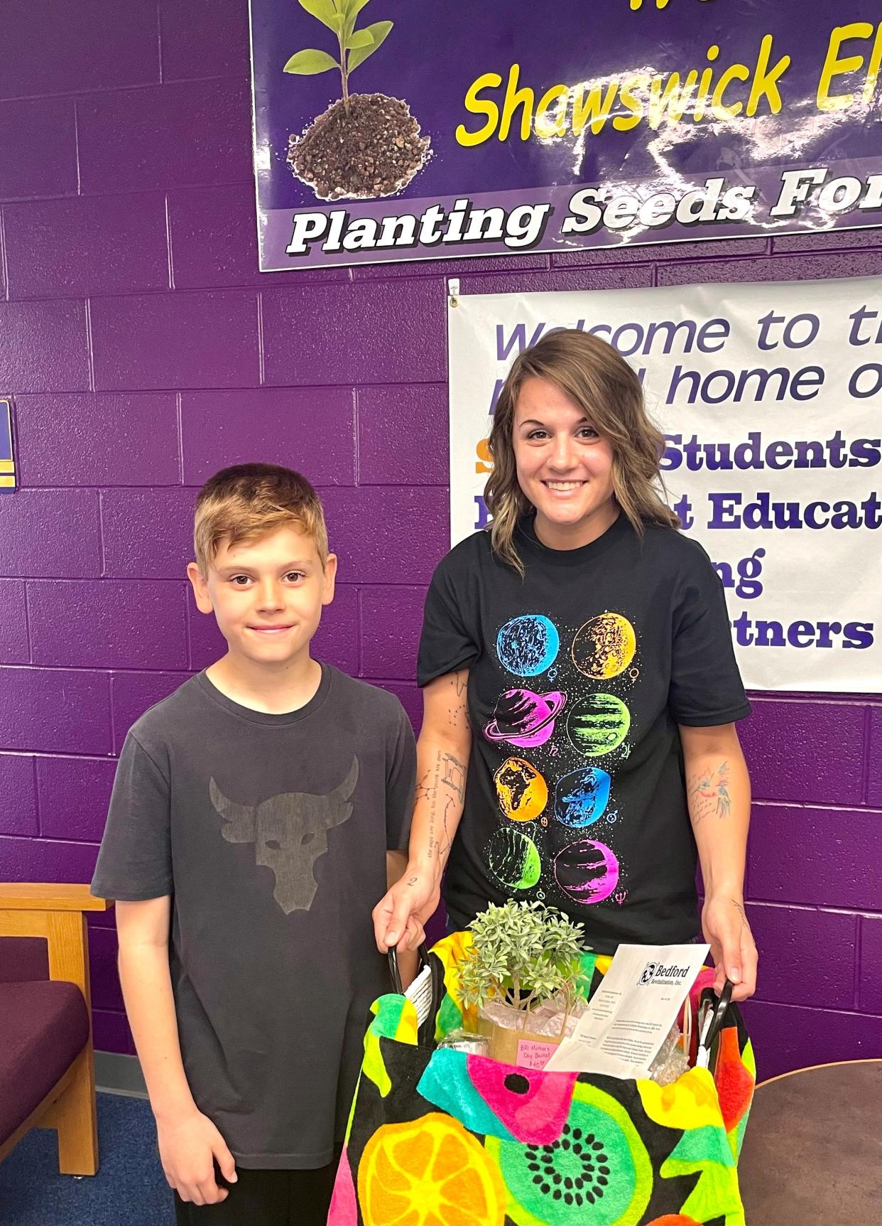 Brody Phillips poses for a picture alongside his mother, Sharissa, after winning this year's Mother's Day Essay Contest sponsored by Bedford Revitalization, Inc.