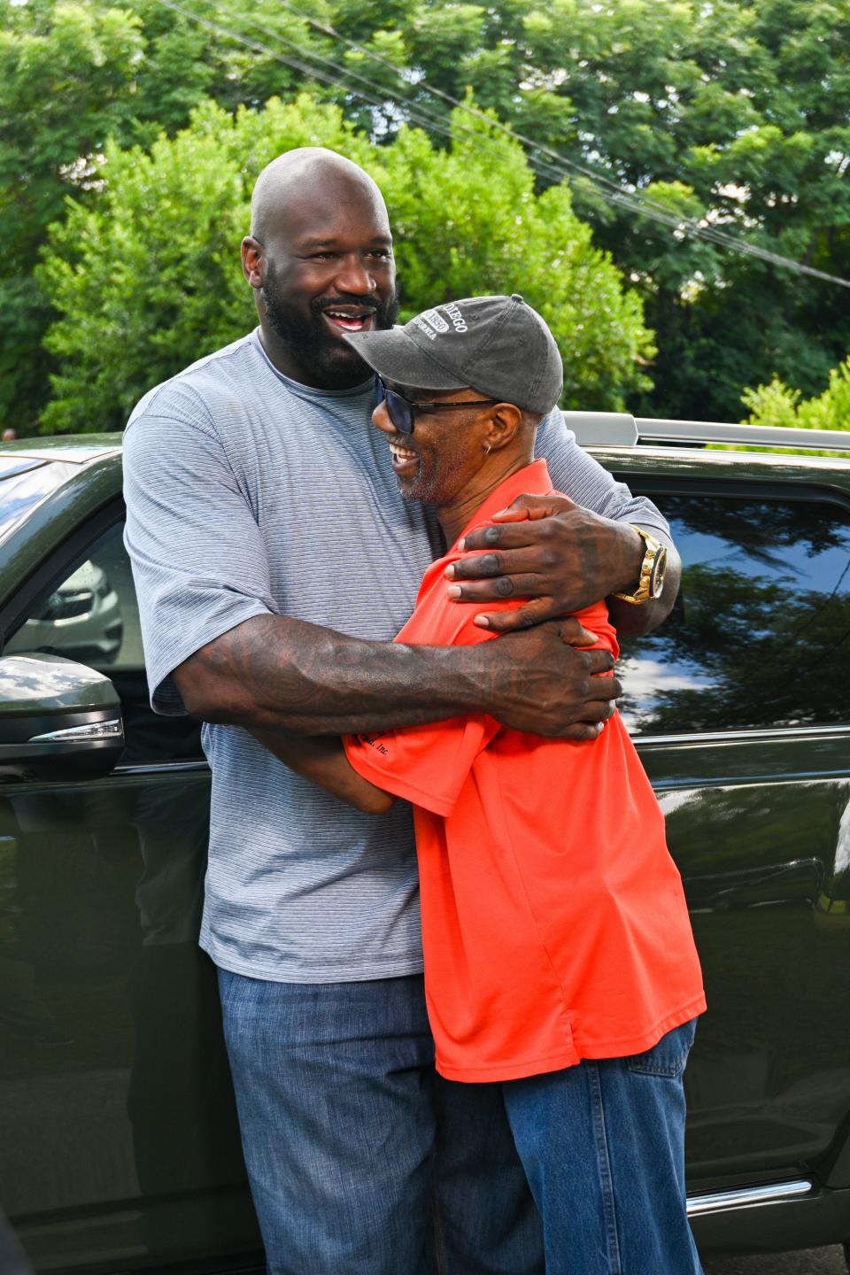 Shaq and Uncle Roy embrace in "Secret Celebrity Renovation." No tears, but deep thanks.