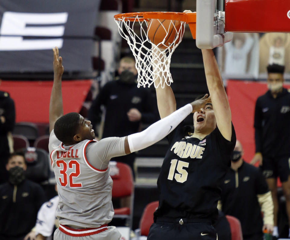 Purdue center Zach Edey, right, dunks the ball against Ohio State forward E.J. Liddell during the second half of an NCAA college basketball game in Columbus, Ohio, Tuesday, Jan. 19, 2021. (AP Photo/Paul Vernon)