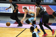 Miami Heat guard Duncan Robinson, left is fouled by Philadelphia 76ers center Joel Embiid (21) during the first half of an NBA basketball game Thursday, May 13, 2021, in Miami. (AP Photo/Lynne Sladky)