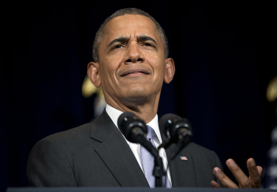 President Barack Obama reacts as he is interrupted by a heckler in the audience during his speech at the general session of the Democratic National Committee winter meeting in Washington, Friday, Feb. 28, 2014. (AP Photo/Pablo Martinez Monsivais)