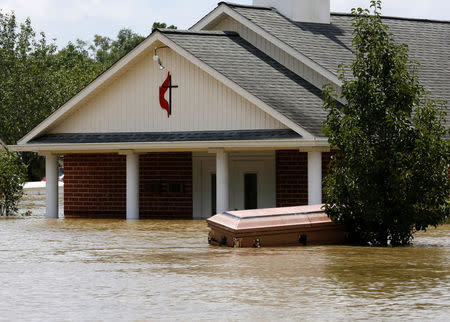A casket is seen in front of a partially submerged church in Ascension Parish, Louisiana. REUTERS/Jonathan Bachman