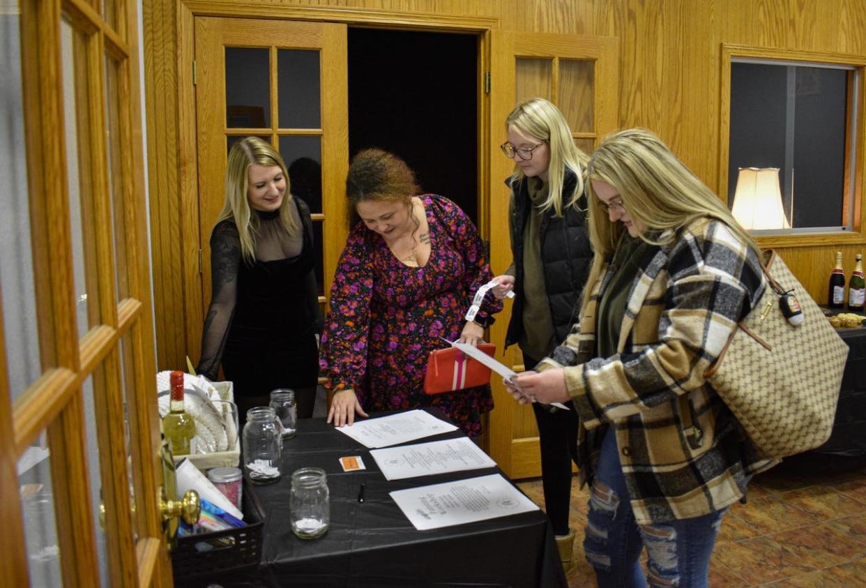 HER House owner Brianna Nickens, left, talks with (left to right) counselor Alicia Boreman and guests Meghan Booth and Baleigh Cote during a Dec. 31 open house.