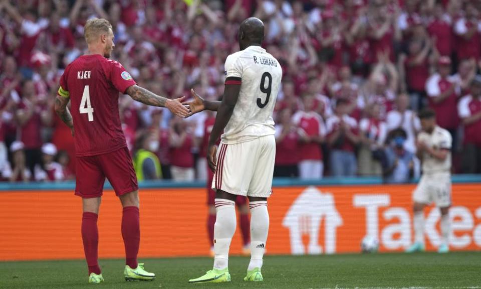 Denmark captain Simon Kjær shakes hands with Belgium’s Romelu Lukaku as the players stop play after 10 minutes in tribute to Christian Eriksen.