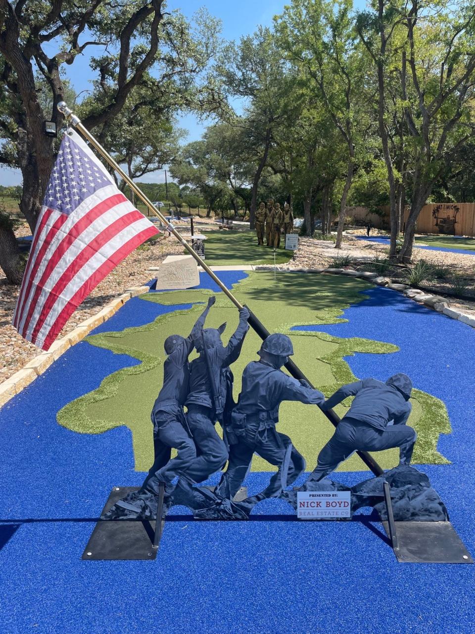 The miniature golf course features holes with military motifs.