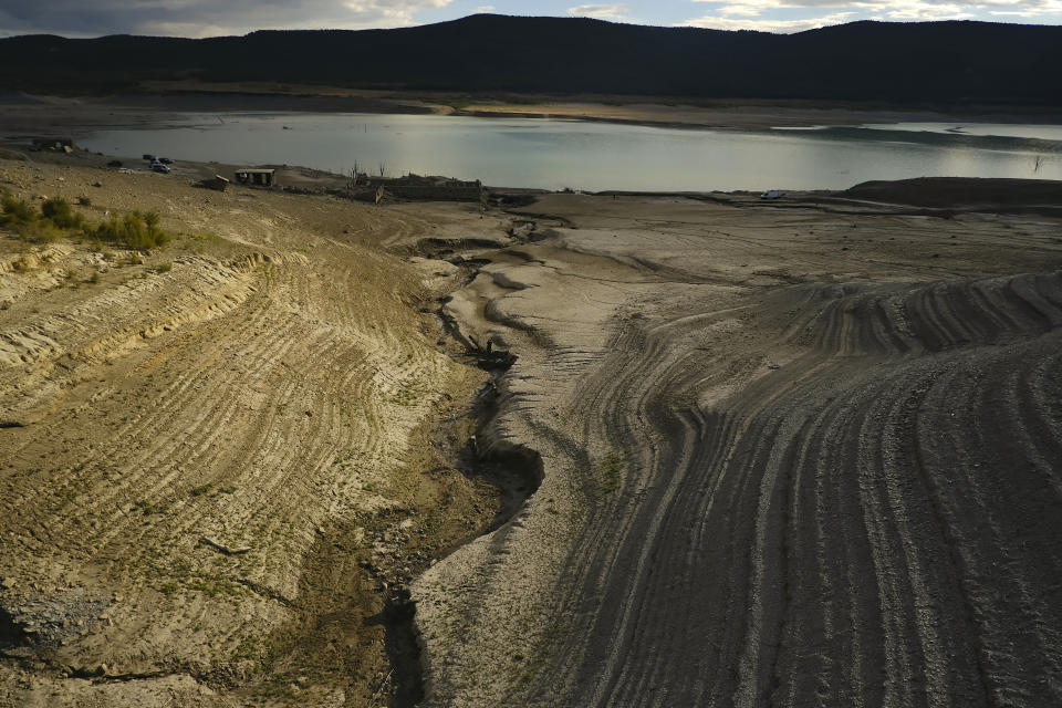 FILE - A view at Yesa's reservoir affected by drought, on a sunny summer day in Yesa, around 55 kilometers (34,17 miles), from Pamplona, northern Spain, on Sept. 14, 2022. Spain has officially entered a period of a long-term drought owing to high temperatures and low rainfall over the past three years and likely faces another year of heatwaves and forest fires, the country’s weather agency Aemet said Friday March 17, 2023. (AP Photo/Alvaro Barrientos, File)