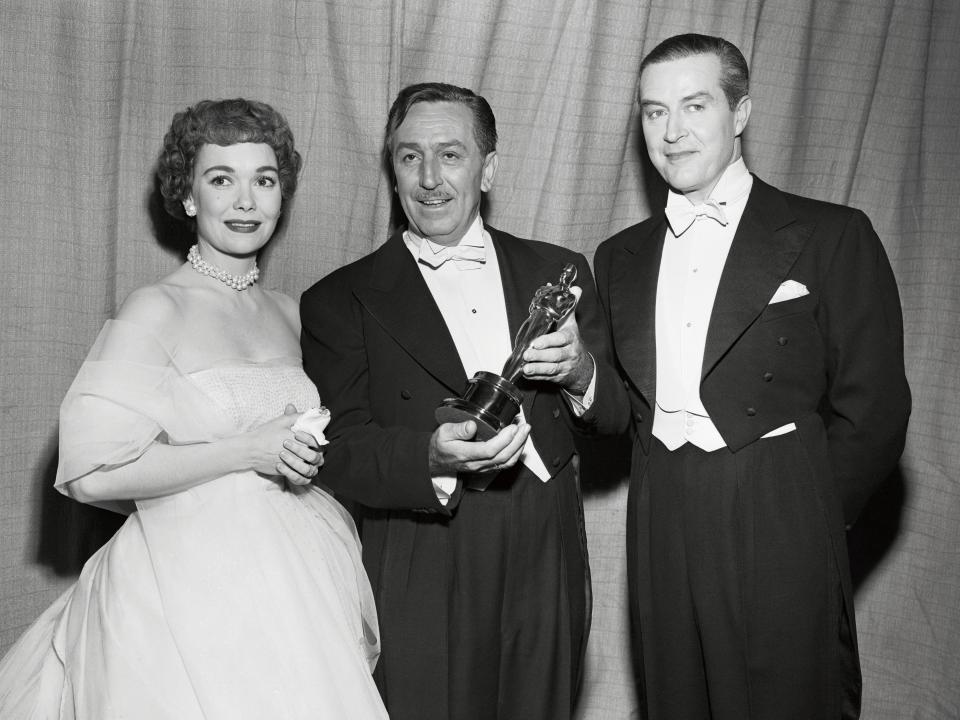 From left to right: Jane Wyman, Walt Disney, and Ray Milland. Disney poses with his Oscar at the 25th Academy Awards in 1953.