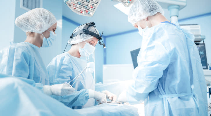 surgeons operating on a patient