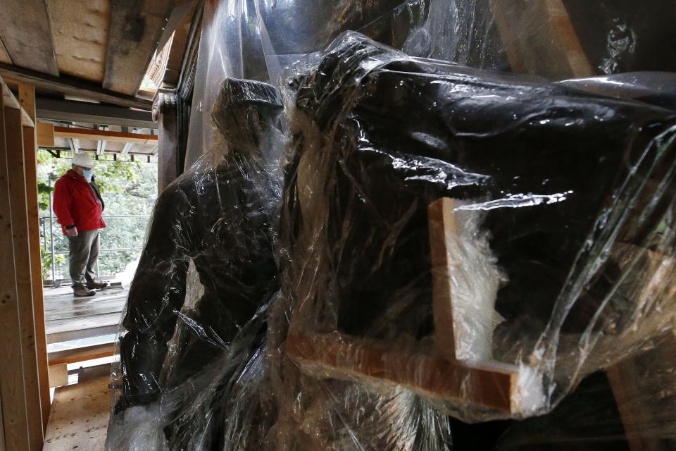 Protective plastic covers the bronze bas-relief of the Shaw 54th Regiment memorial during the restoration process Friday, July 17, 2020, in Boston. Amid the national reckoning on racism, the memorial to the first Black regiment of the Union Army, the Civil War unit popularized in the movie "Glory,” is facing scrutiny. (AP Photo/Michael Dwyer)