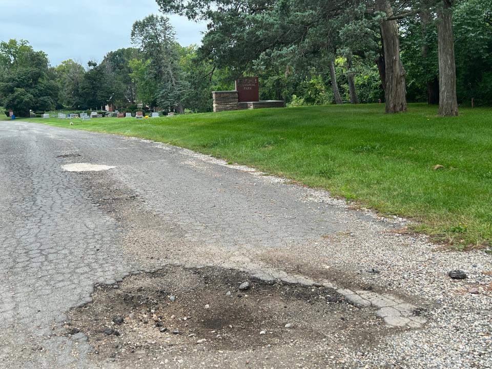 A photo provided by Nancy Vogl to the State Journal shows a large pothole on a driveway inside Deepdale Memorial Gardens in Delta Township.