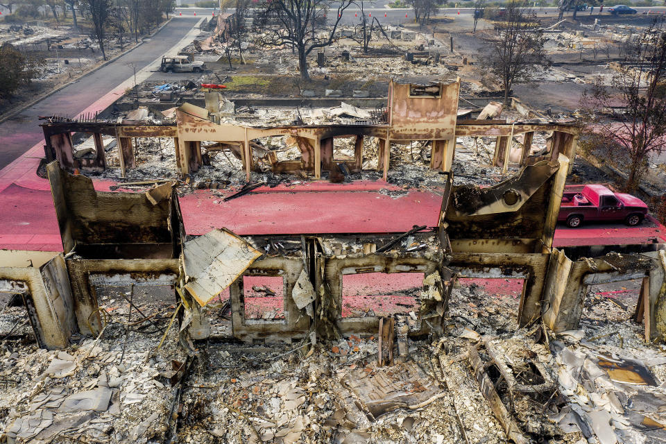 Facades stand among rubble at the Parkview Townhomes in Talent, Ore., on Wednesday, Sept. 16, 2020, following the Almeda Fire, (AP Photo/Noah Berger)