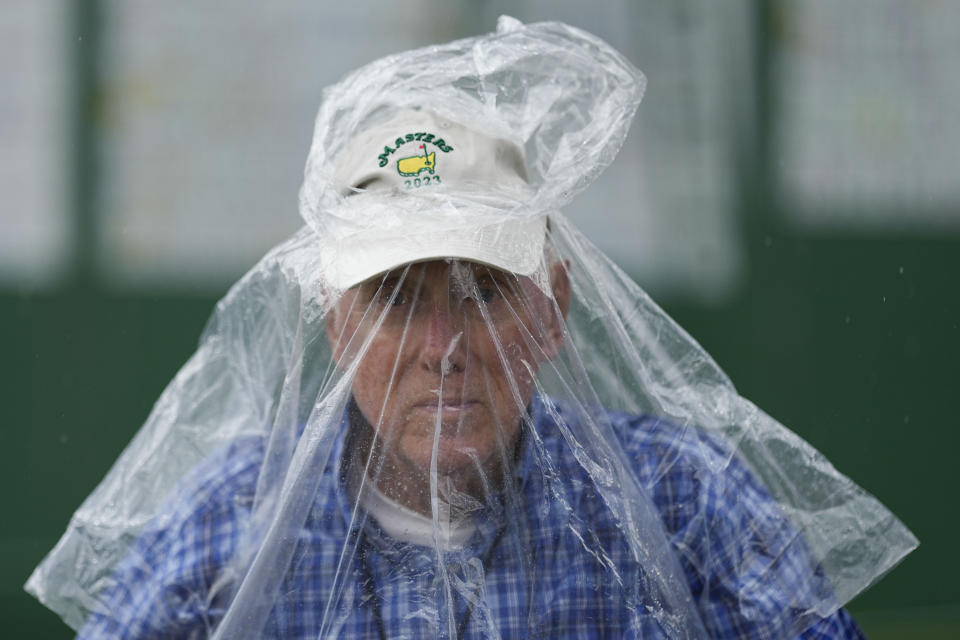 Pete Meredith leaves the course after play was suspended during the second round of the Masters golf tournament at Augusta National Golf Club on Friday, April 7, 2023, in Augusta, Ga. (AP Photo/David J. Phillip)