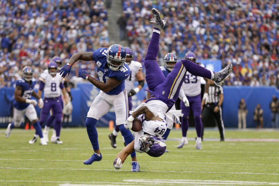 Minnesota Vikings tight end Irv Smith (84) makes a catch as he flips over New York Giants free safety Antoine Bethea (41) during the second quarter of an NFL football game, Sunday, Oct. 6, 2019, in East Rutherford, N.J. (AP Photo/Adam Hunger)