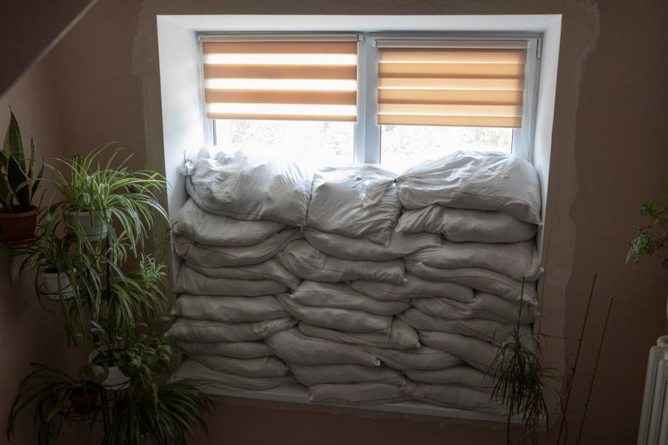 Sandbags piled in front of a window (Reuters)