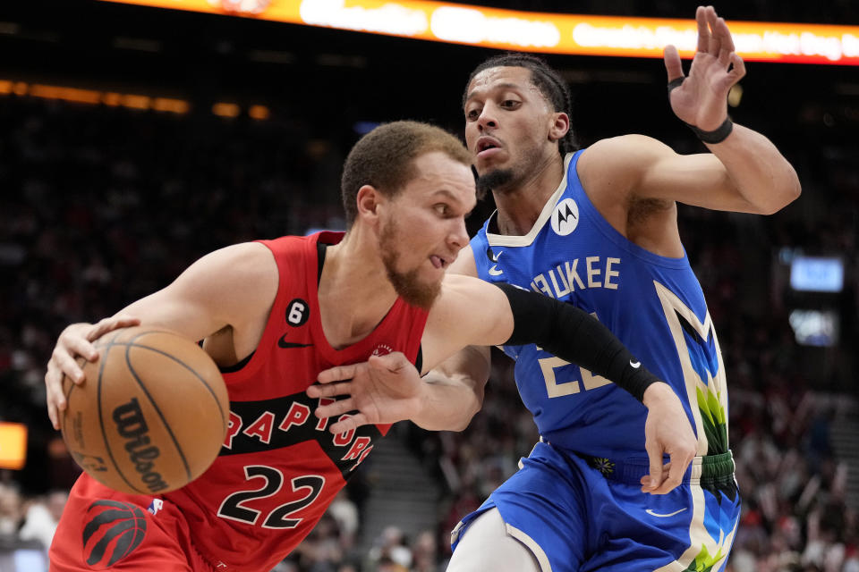 Toronto Raptors guard Malachi Flynn (22) tries to get around Milwaukee Bucks guard Lindell Wigginton (28) during second half of an NBA basketball game in Toronto, Sunday, April 9, 2023. (Frank Gunn /The Canadian Press via AP)