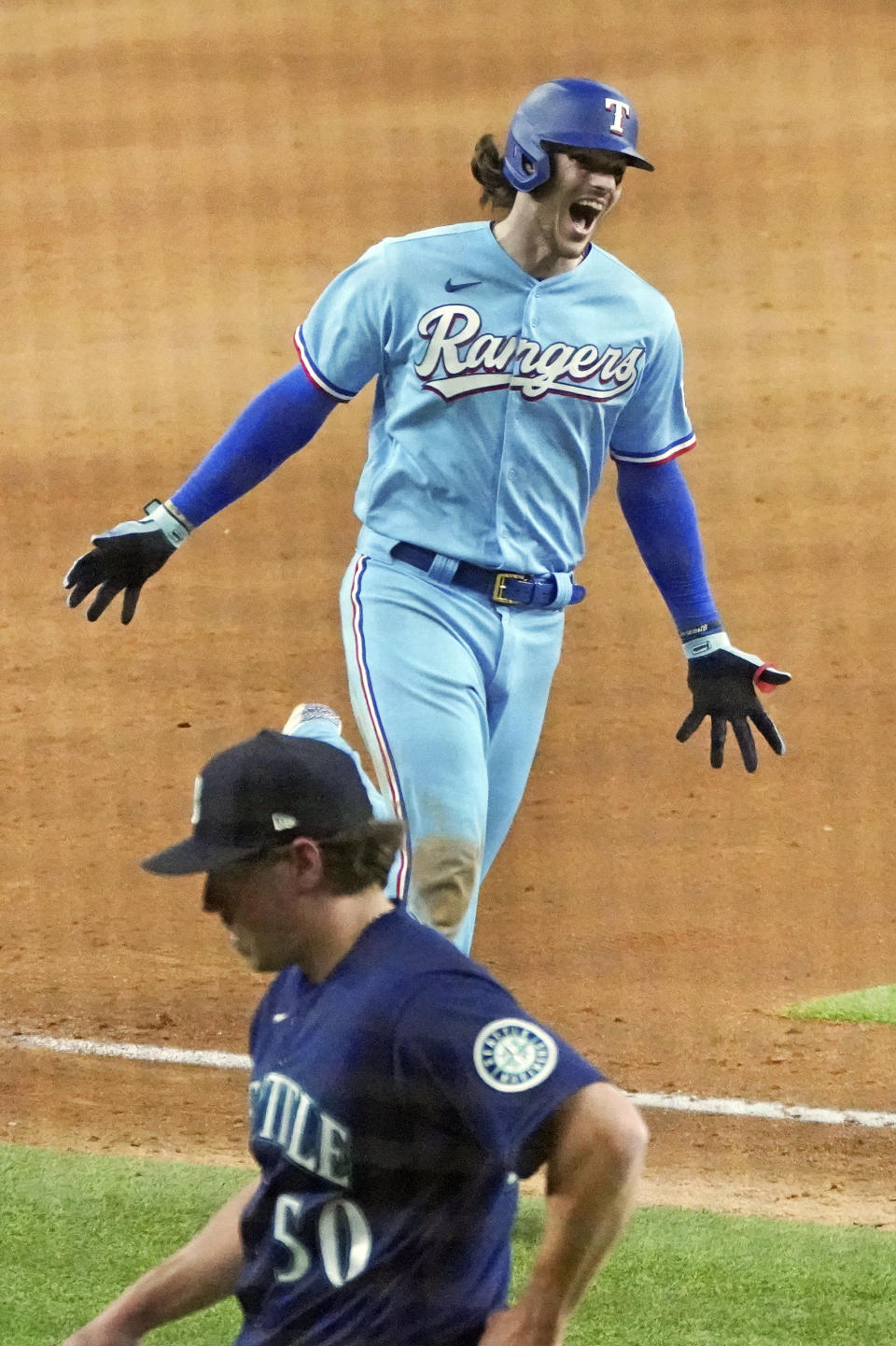 Texas Rangers designated hitter Jonah Heim rounds third base after hitting the game-winning home run against Seattle Mariners relief pitcher Erik Swanson (50) in the ninth inning of a baseball game, Sunday, Aug. 1, 2021, in Arlington, Texas. (AP Photo/Louis DeLuca)