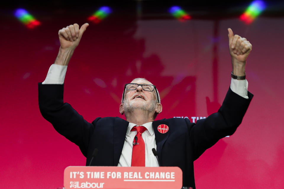 Jeremy Corbyn, Leader of Britain's opposition Labour Party gestures on stage at the launch of Labour's General Election manifesto, at Birmingham City University, England, Thursday, Nov. 21, 2019. Britain goes to the polls on Dec. 12. (AP Photo/Kirsty Wigglesworth)