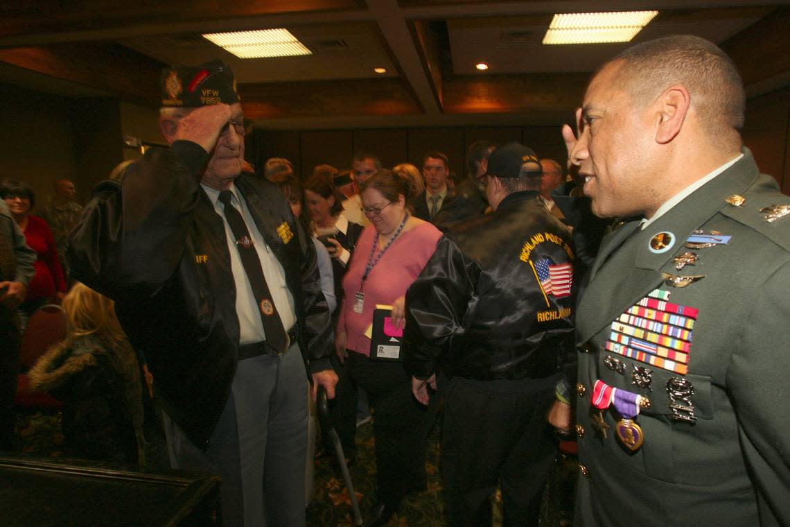 Army Staff Sgt. Misipati “Semi” Bird, is honored with a salute in 2006 from World War II veteran Cliff Dykeman of West Richland after Bird received the Bronze Star with Valor Device, Purple Heart and Army Commendation Medal for valor in Iraq.